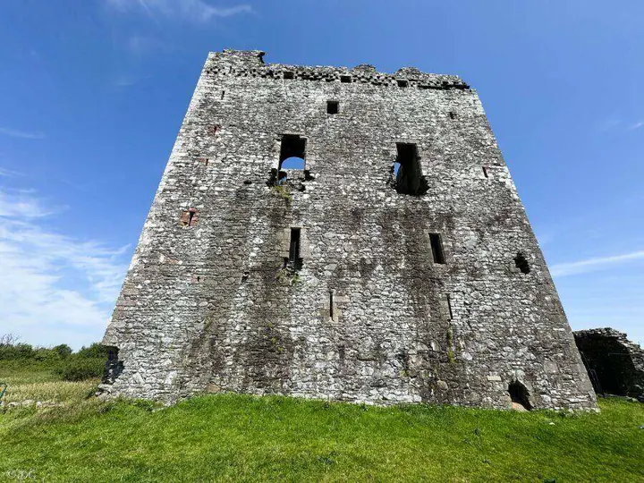 Broad stone wall of Threave Castle with irregular window openings