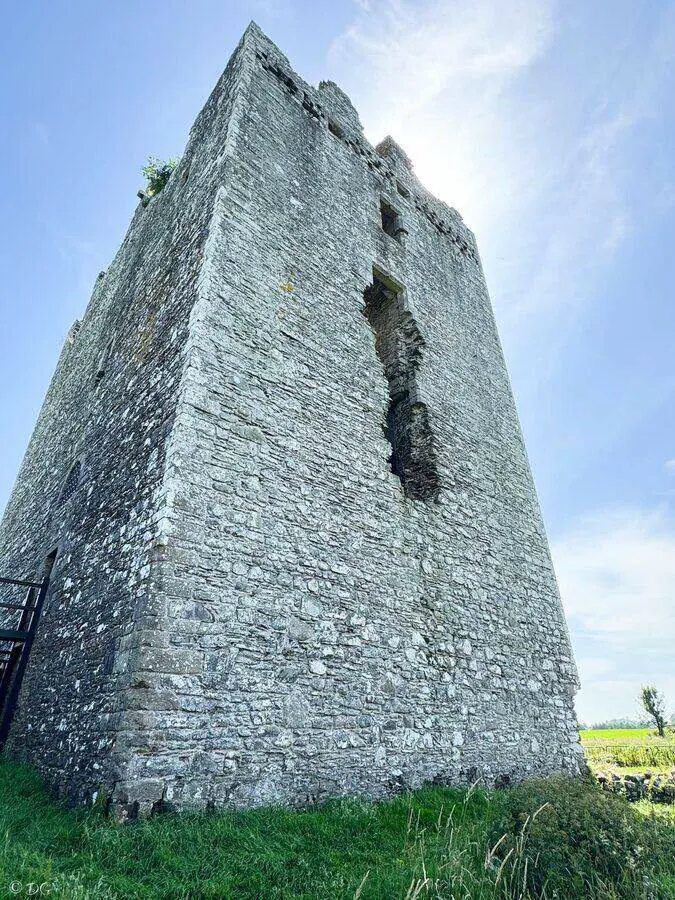 Tall corner of Threave Castle tower beneath a blue sky