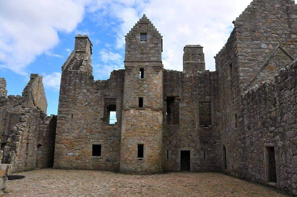 Tolquhon Castle courtyard with a central turret and roofless stone walls