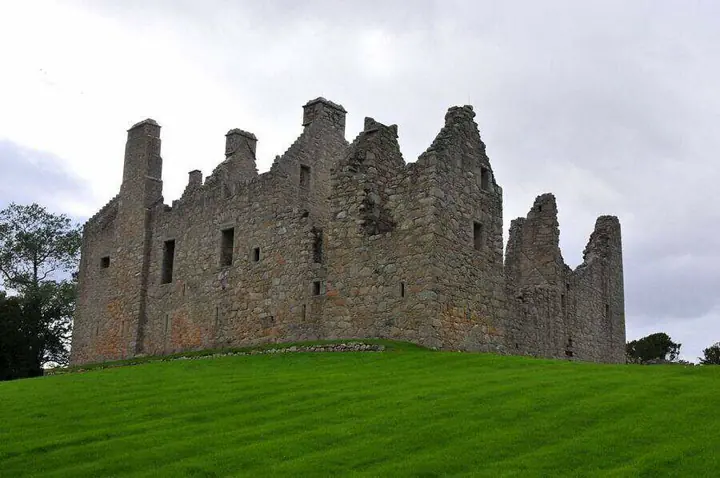 Tolquhon Castle gabled stone walls above a gently sloping lawn