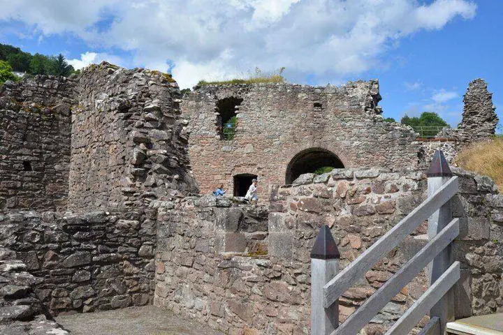 Urquhart Castle arched entrance seen beyond a wooden railing