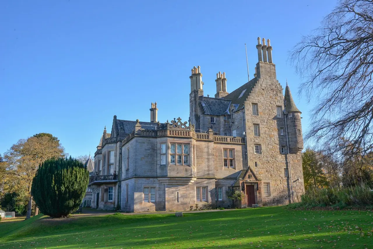 Lauriston Castle tower, turrets and tall chimneys above the lawn