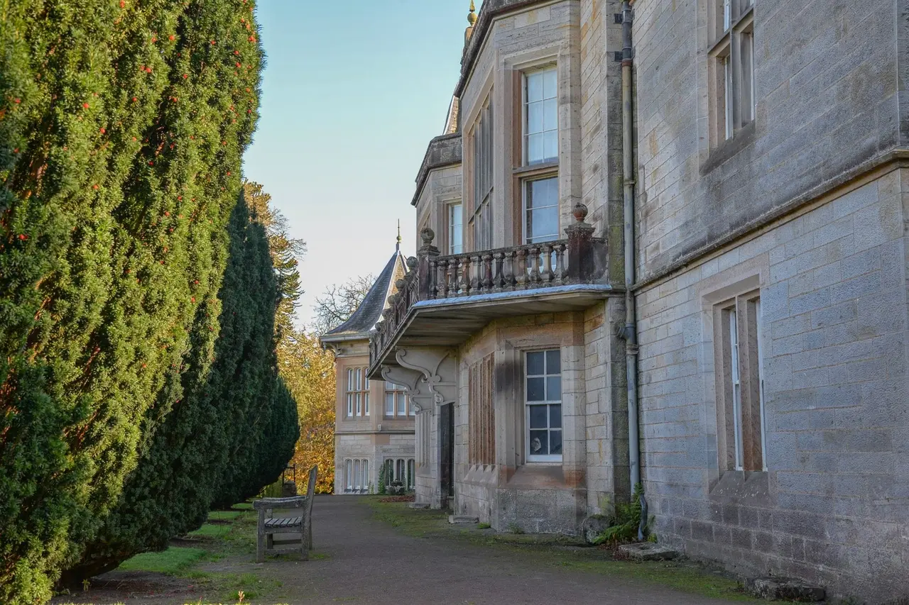 Stone balcony and tall windows along the garden path at Lauriston Castle